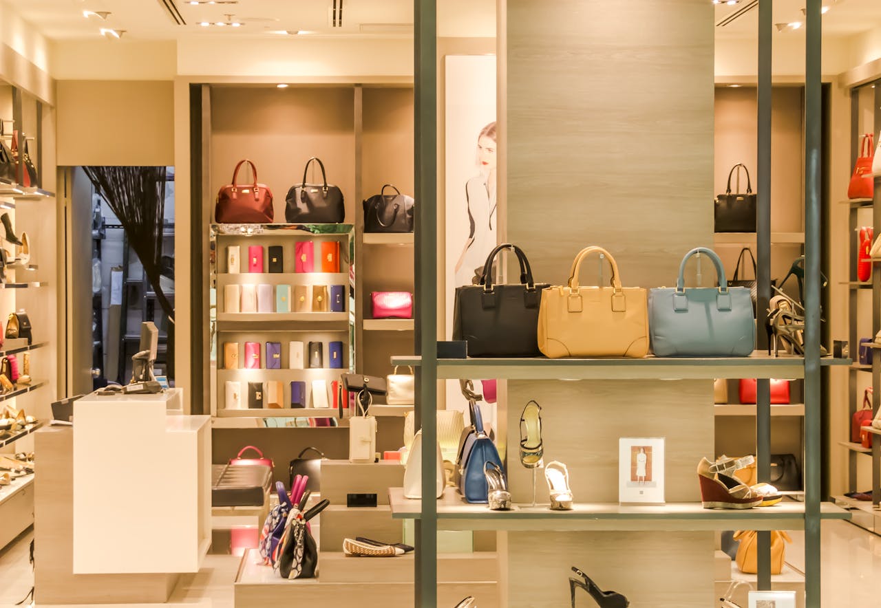 home-hero Chic boutique with a variety of handbags and shoes elegantly displayed on shelves.